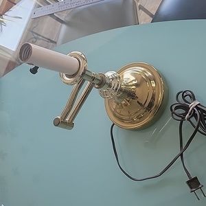 Golden adjustable electric lamp.